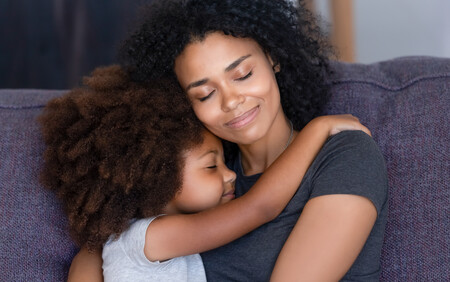 woman and child hugging on couch