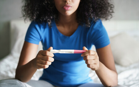 woman looking at pregnancy test