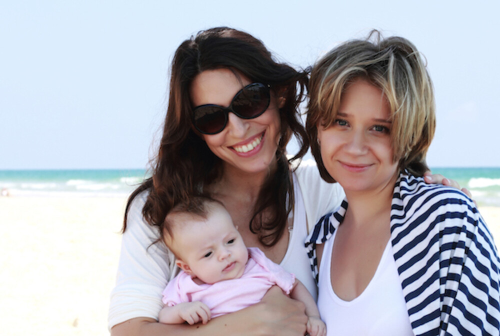 couple with baby on beach