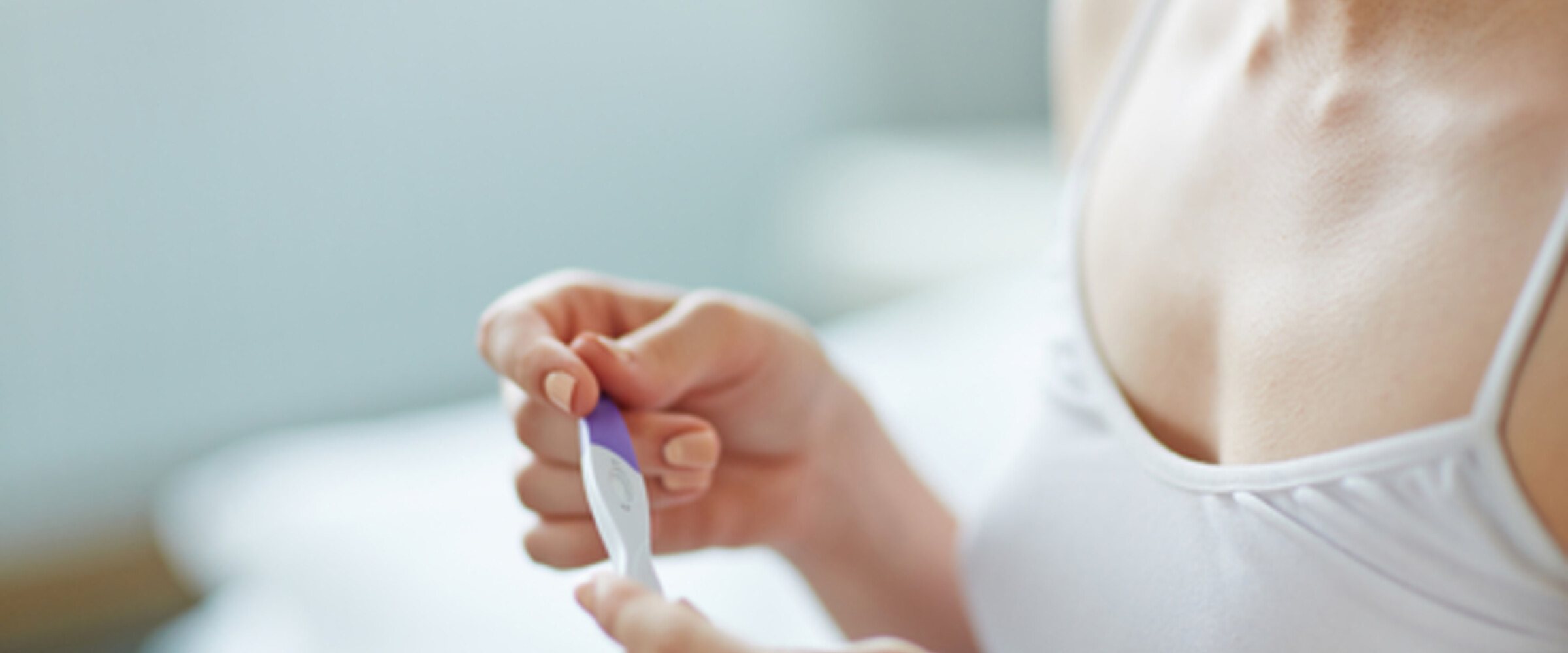 woman looking at pregnancy test